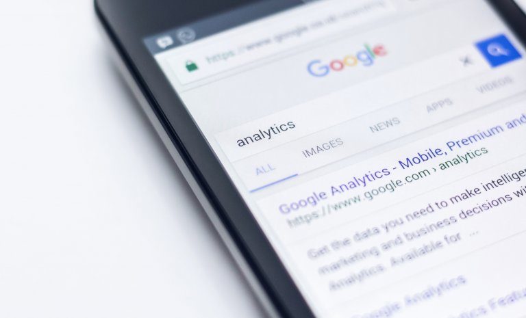 smart phone displaying Google search results for the search query "analytics"