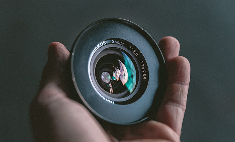 closeup of a Nikkor 24mm camera lens