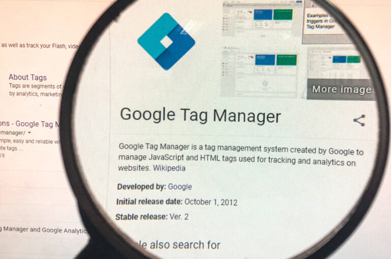 black magnifying glass magnifying the definition of Google Tag Manager on a computer screen