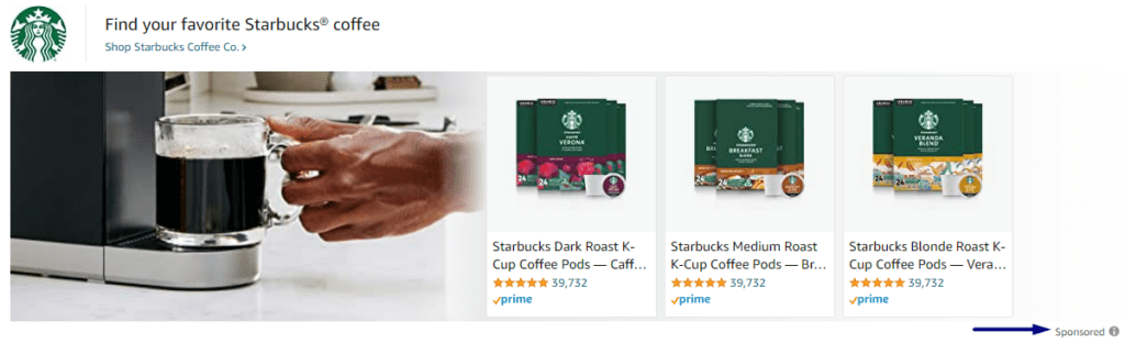 Clear coffee mug filled with hot coffee and boxes of coffee pods next to the coffee maker