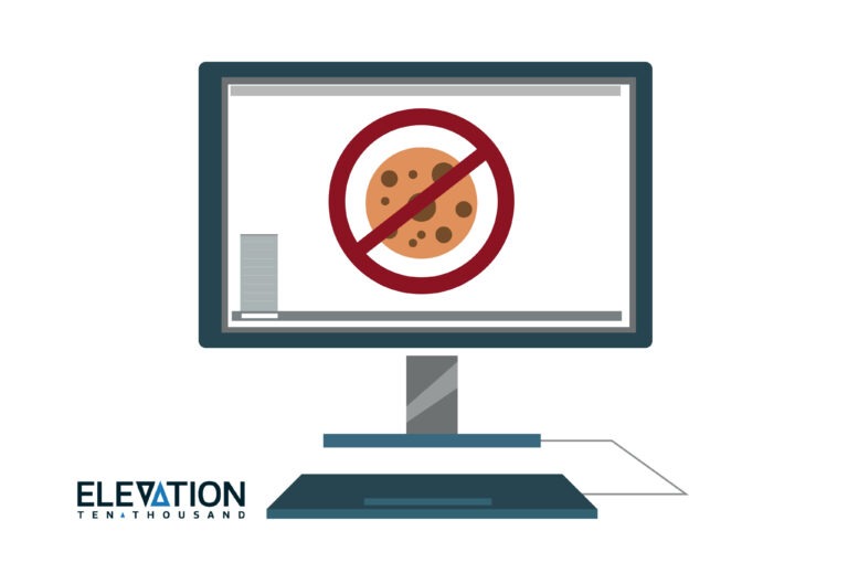 gray computer with a brown chocolate chip cookie on the screen