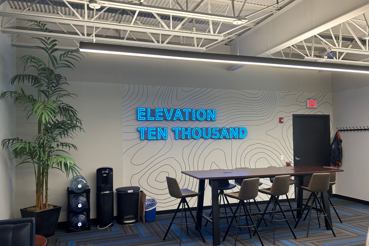 Elevation Ten Thousand sign on wall