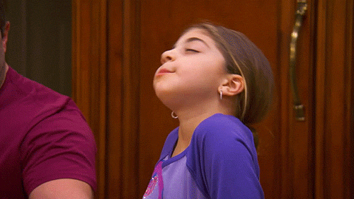 little girl waving hand backwards