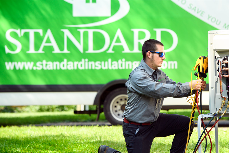 Standard technician performing maintenance outdoors.